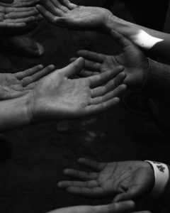 a group of people holding their hands together